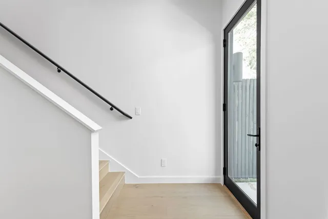 a view of staircase with white walls and a window