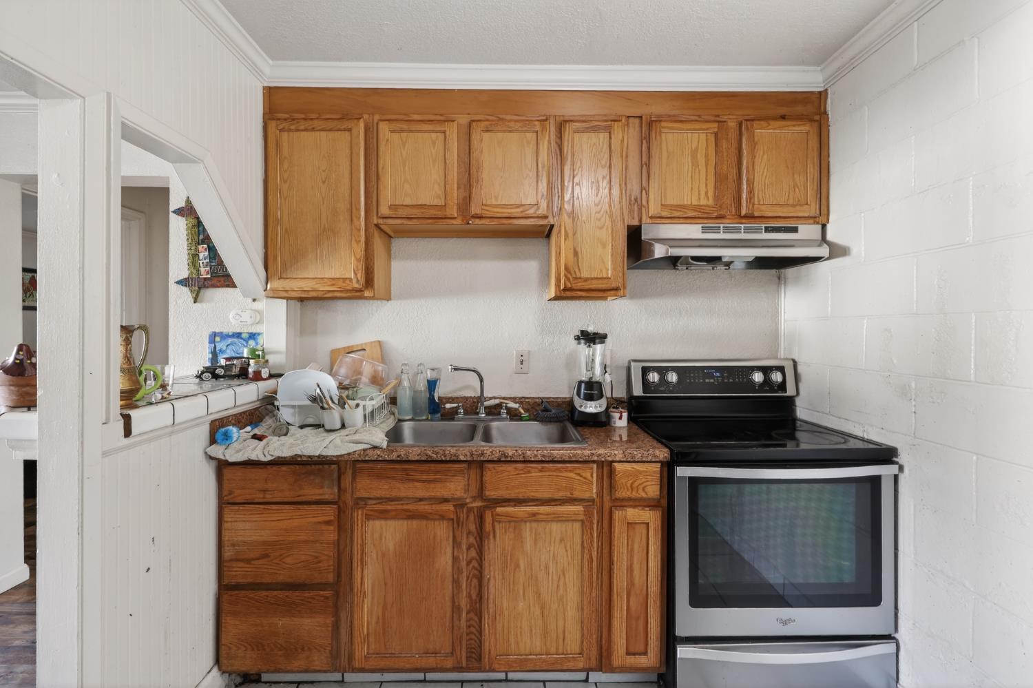 628 Olive Street Sonora, CA 95370 - Photo 31 of 46 a kitchen with stainless steel appliances granite countertop a stove sink and cabinets