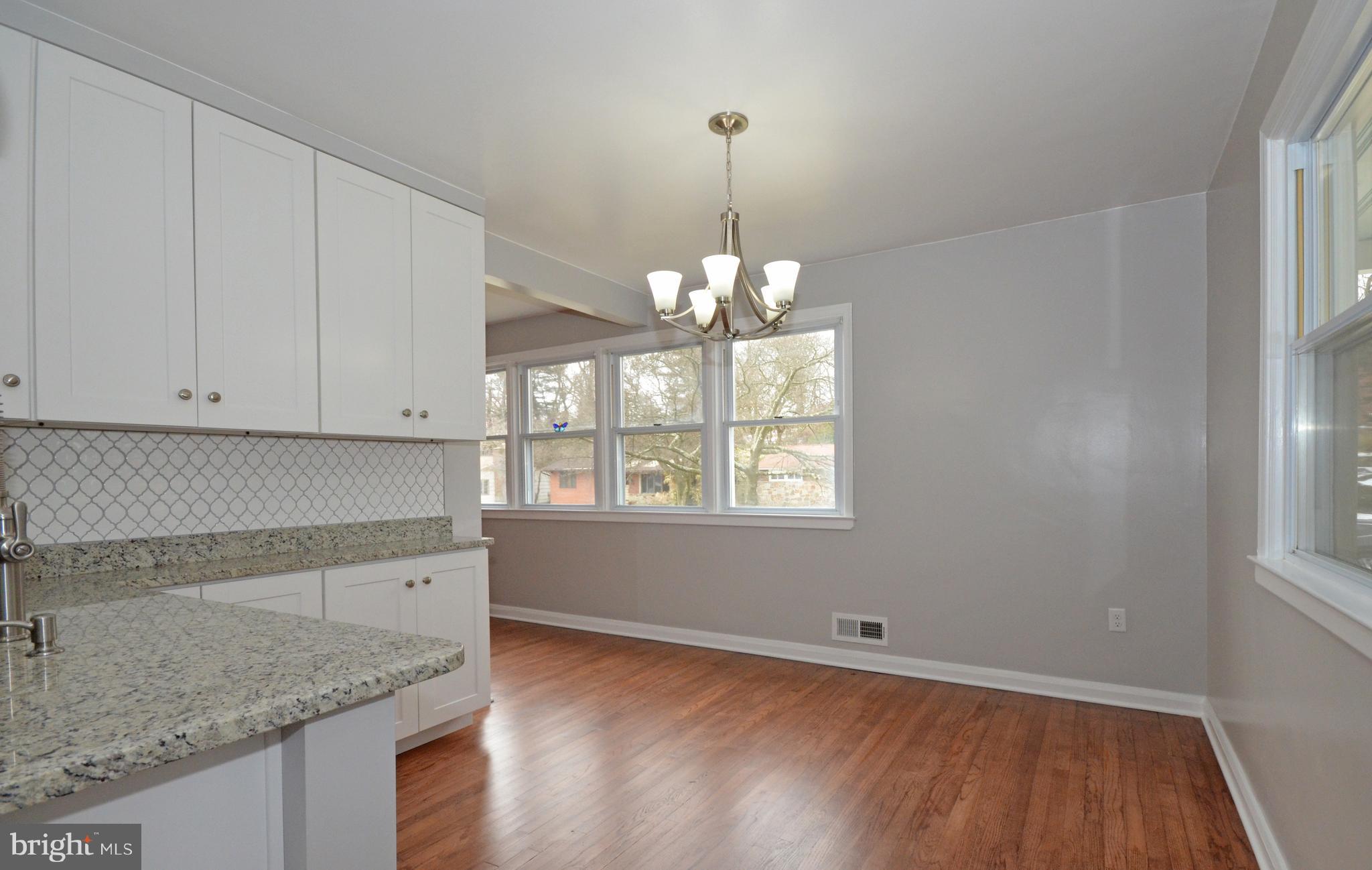 1318 Glendale Road Baltimore, MD 21239 - Photo 14 of 30 a kitchen with granite countertop white cabinets and a wooden floor