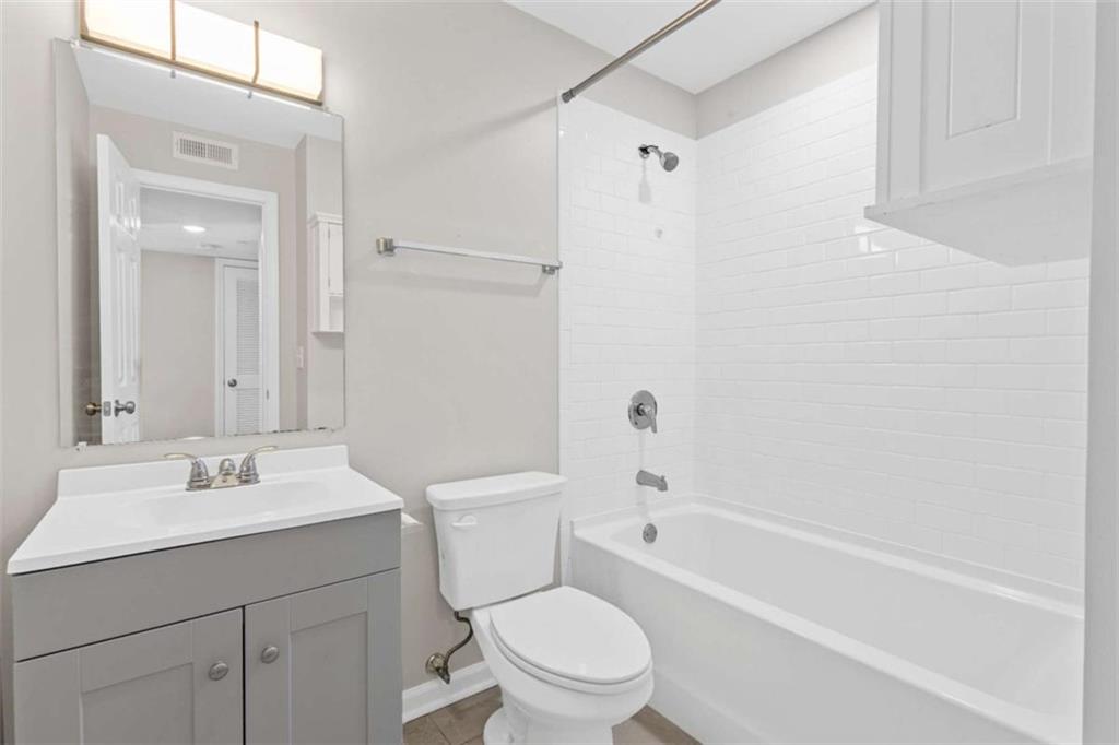 1166 Booth Road, Unit 407 Marietta, GA 30008 - Photo 16 of 18 a bathroom with a sink toilet and shower