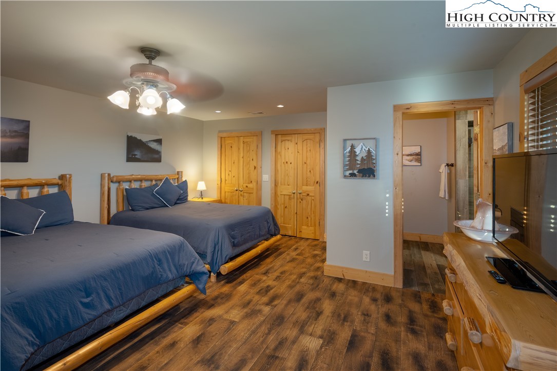 546 Big Sky Road Ferguson, NC 28624 - Photo 16 of 23 a bedroom with a bed and a flat tv screen on dresser