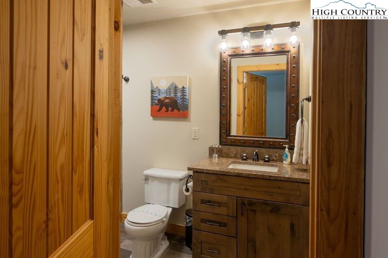 546 Big Sky Road Ferguson, NC 28624 - Photo 21 of 23 a bathroom with a granite countertop sink toilet and mirror