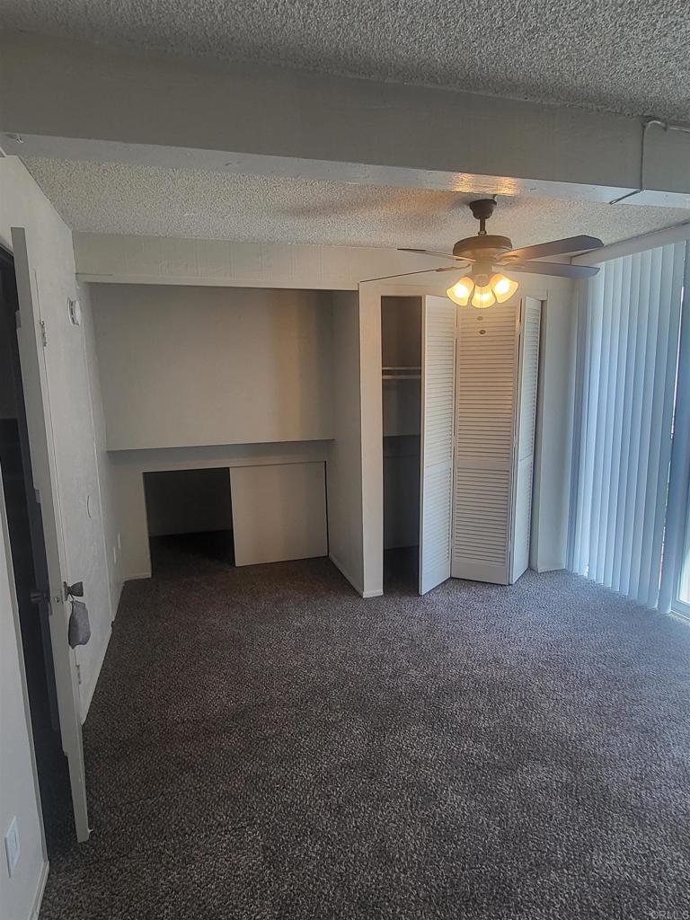 2319 Caringa Way, Unit 56 Carlsbad, CA 92009 - Photo 18 of 24 an empty room with chandelier fan