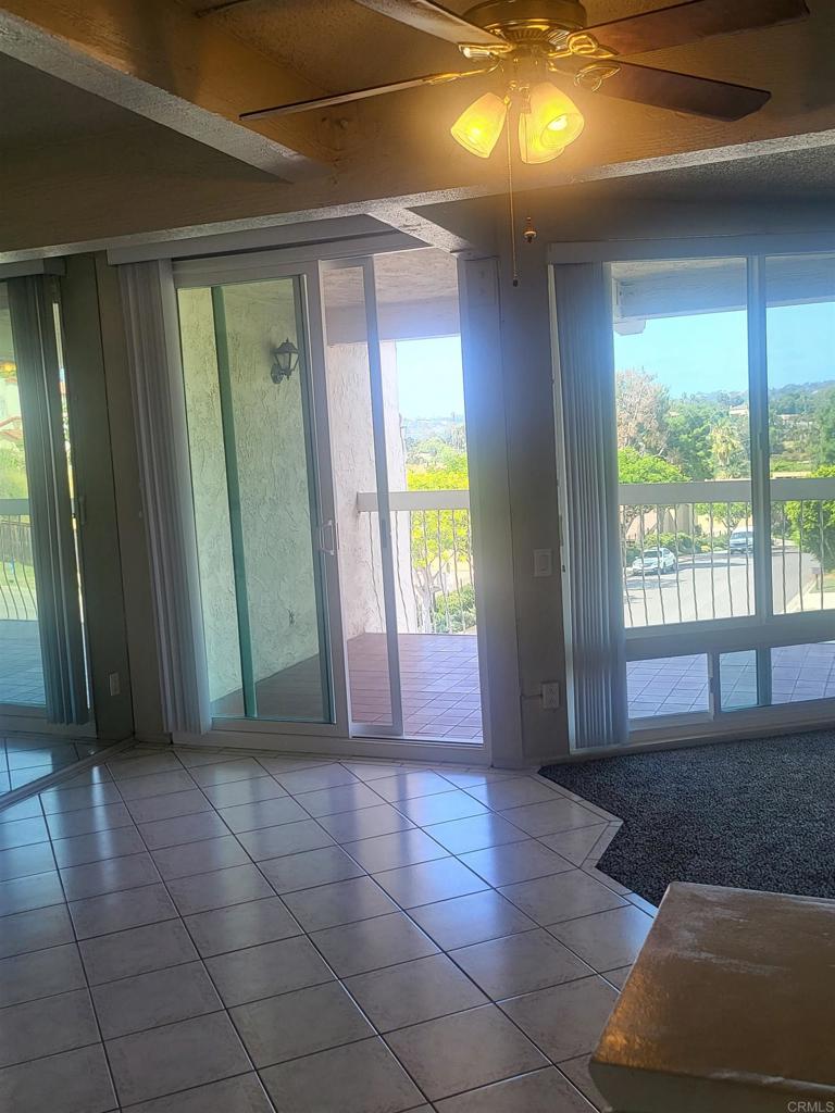 2319 Caringa Way, Unit 56 Carlsbad, CA 92009 - Photo 6 of 24 a view of entryway with a floor to ceiling window and a fireplace
