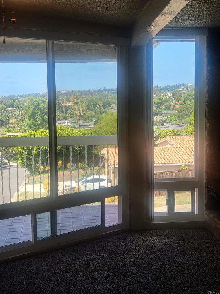 2319 Caringa Way, Unit 56 Carlsbad, CA 92009 - Photo 7 of 24 a living room with large windows