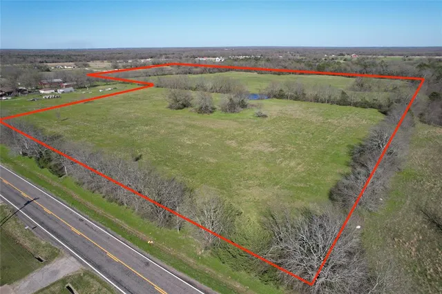 a view of a field with an ocean