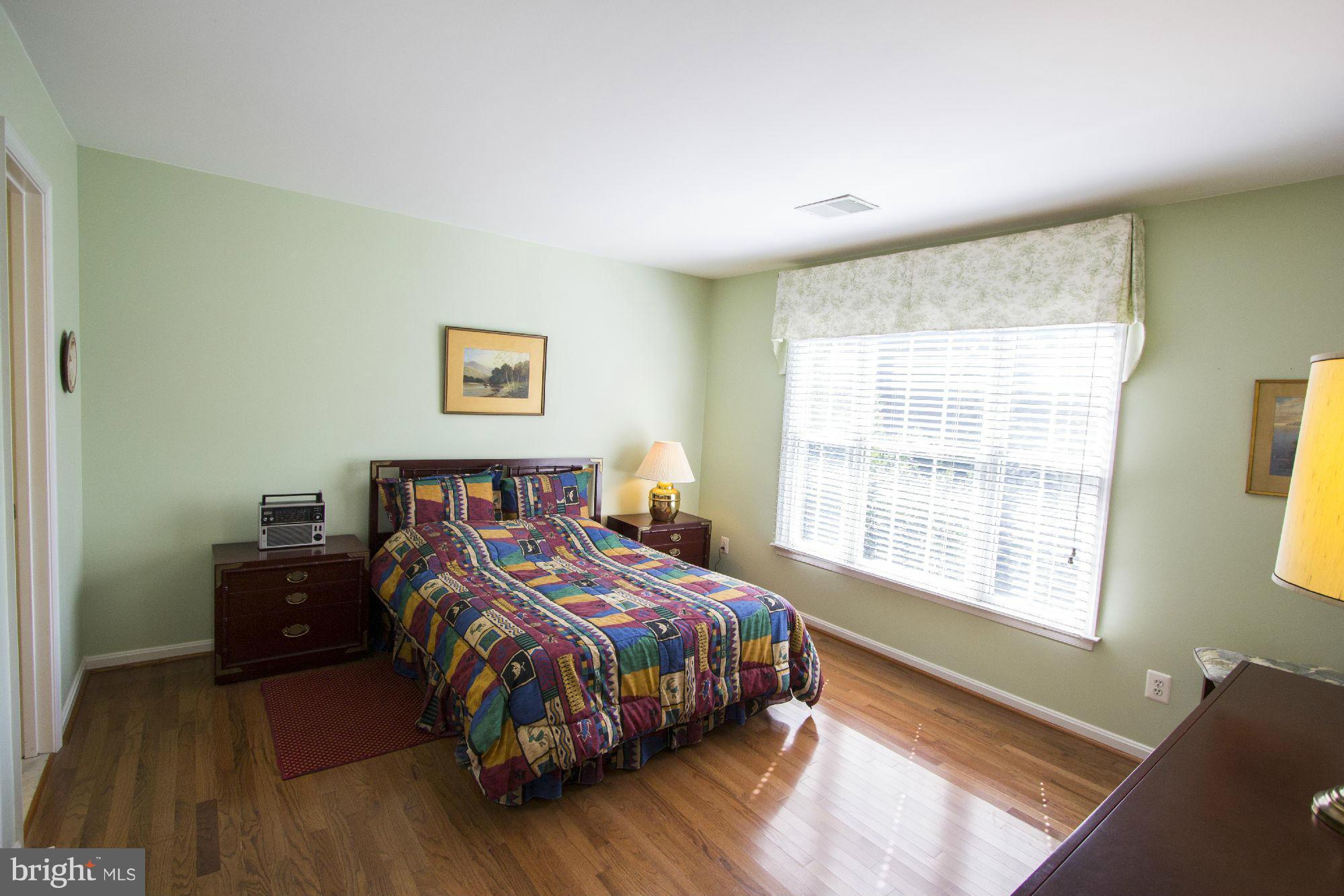 1827 Beulah Road Vienna, VA 22182 - Photo 20 of 30 a bedroom with a bed and wooden floor