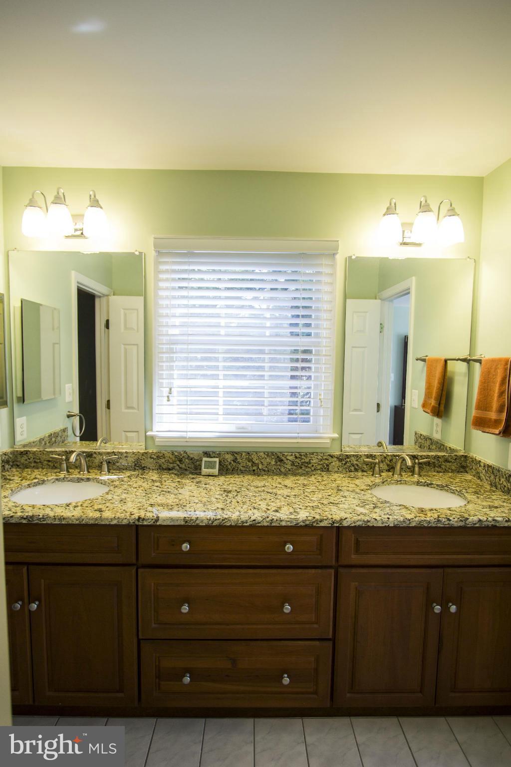 1827 Beulah Road Vienna, VA 22182 - Photo 21 of 30 a bathroom with a granite countertop sink and a mirror