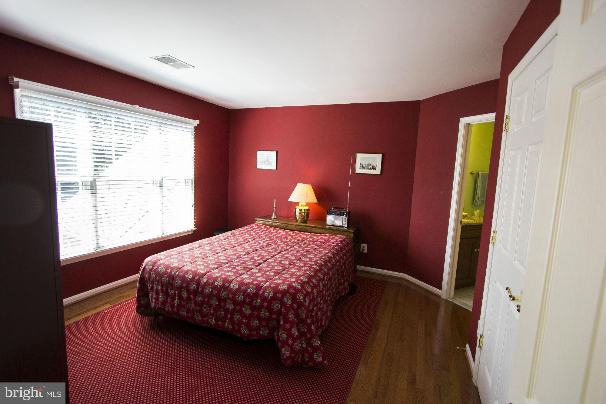 1827 Beulah Road Vienna, VA 22182 - Photo 22 of 30 a bedroom with a bed and wooden floor