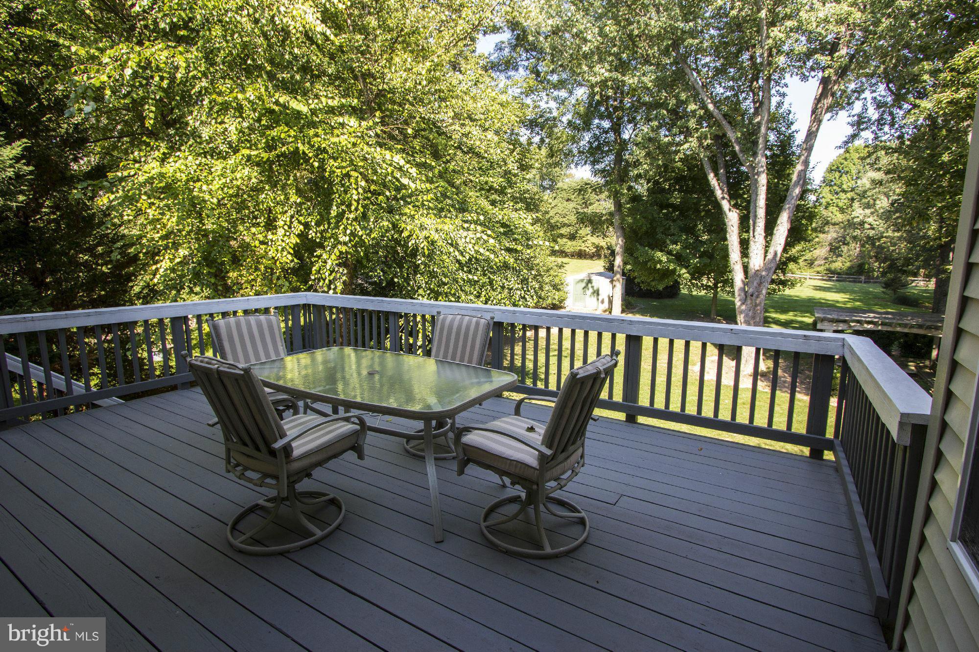 1827 Beulah Road Vienna, VA 22182 - Photo 29 of 30 a view of balcony with wooden floor outdoor seating and trees
