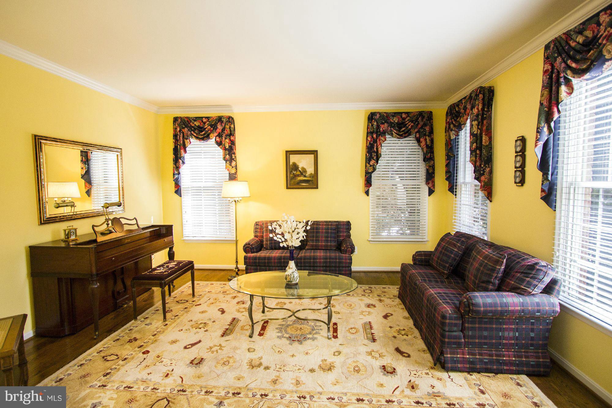 1827 Beulah Road Vienna, VA 22182 - Photo 6 of 30 a living room with furniture and a flat screen tv with kitchen view
