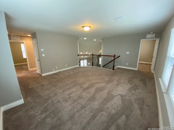 wooden floor in an empty room with a mirror