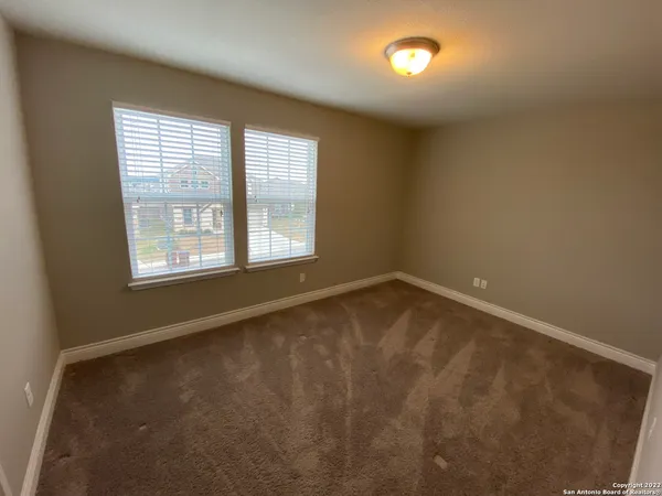 an empty room with a empty space and windows