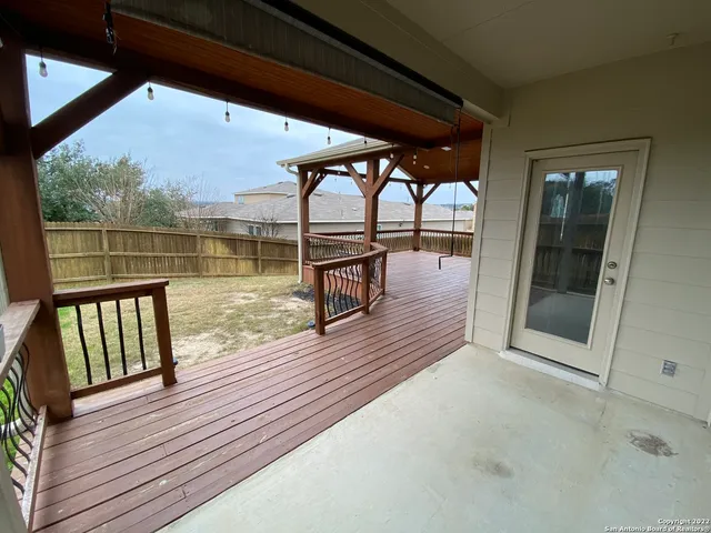 a view of a balcony with wooden floor