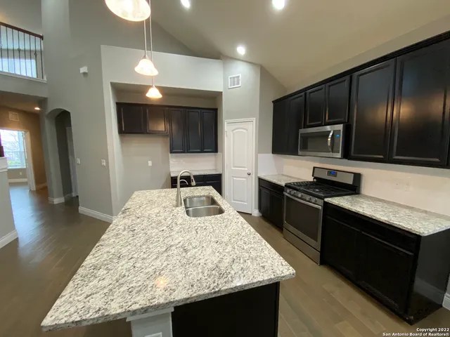 a kitchen with a sink stove and refrigerator