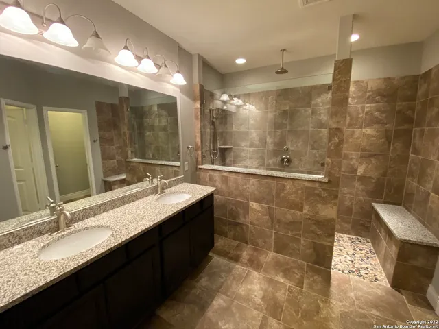 a bathroom with a granite countertop sink mirror and double