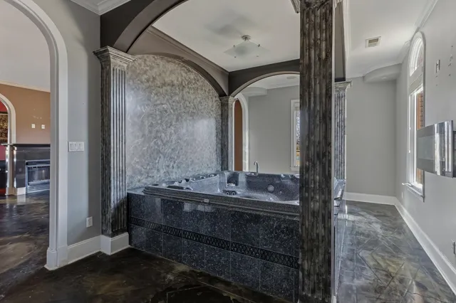 a en suite bathroom with a granite countertop sink and a mirror