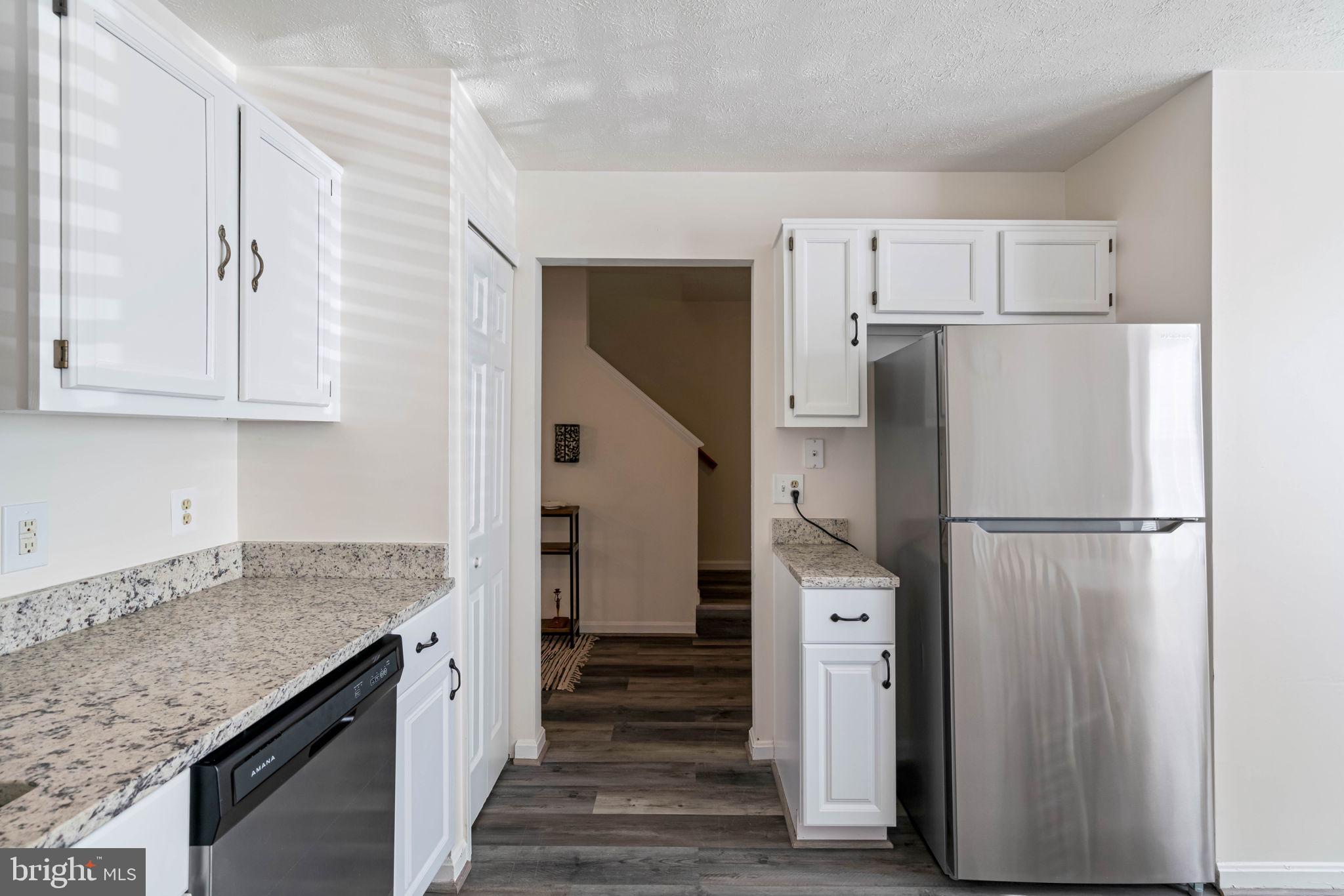 407 Kings Crest Drive Stafford, VA 22554 - Photo 11 of 42 a kitchen with a refrigerator and a sink