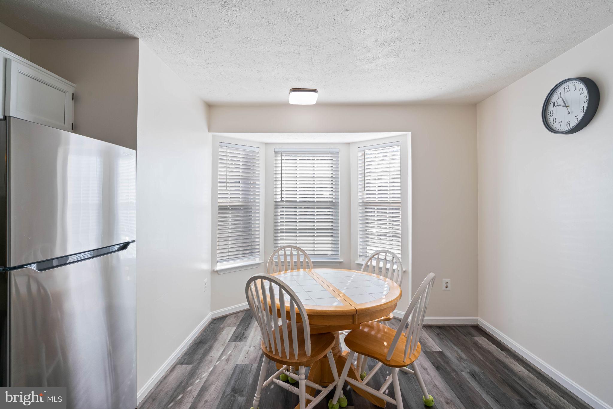 407 Kings Crest Drive Stafford, VA 22554 - Photo 12 of 42 a view of a dining room with furniture window and wooden floor