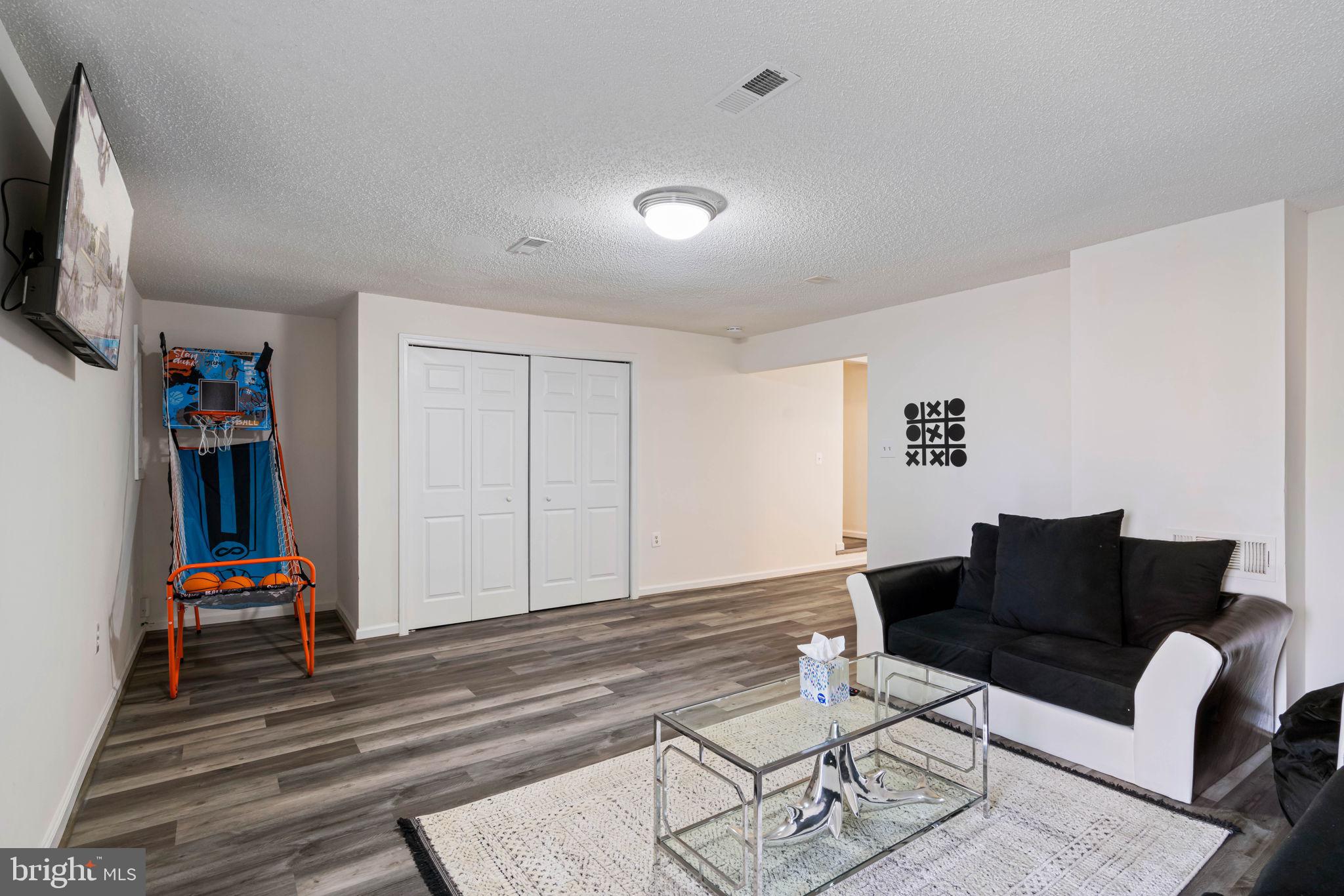407 Kings Crest Drive Stafford, VA 22554 - Photo 29 of 42 a living room with furniture and a flat screen tv
