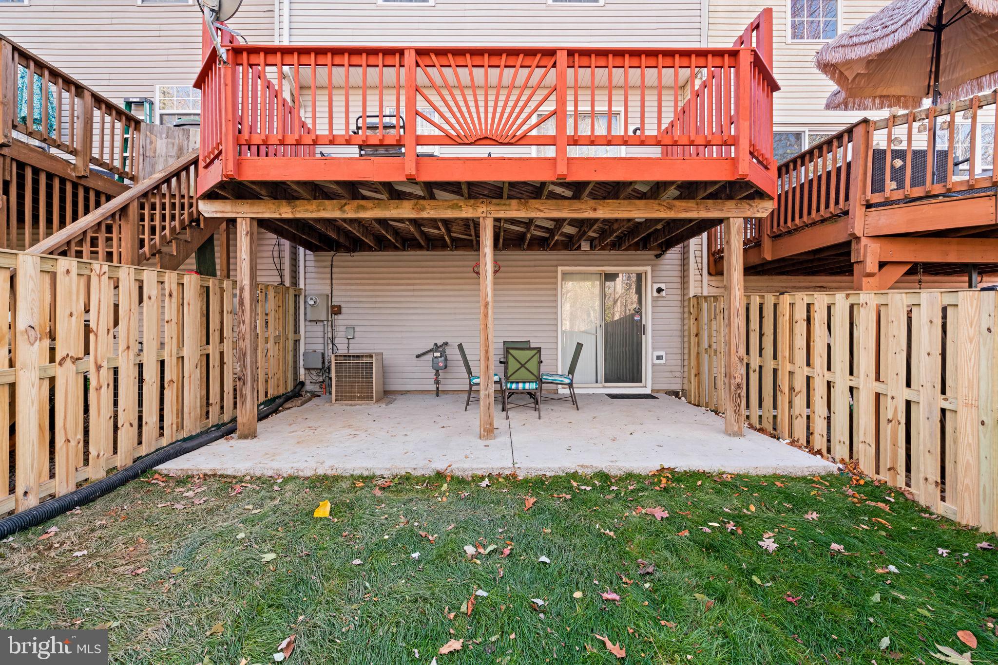 407 Kings Crest Drive Stafford, VA 22554 - Photo 38 of 42 a view of a patio with table and chairs with wooden floor and fence