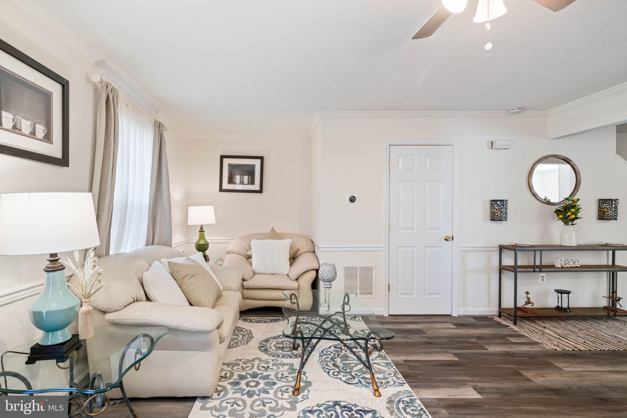407 Kings Crest Drive Stafford, VA 22554 - Photo 42 of 42 a living room with furniture a lamp and a window