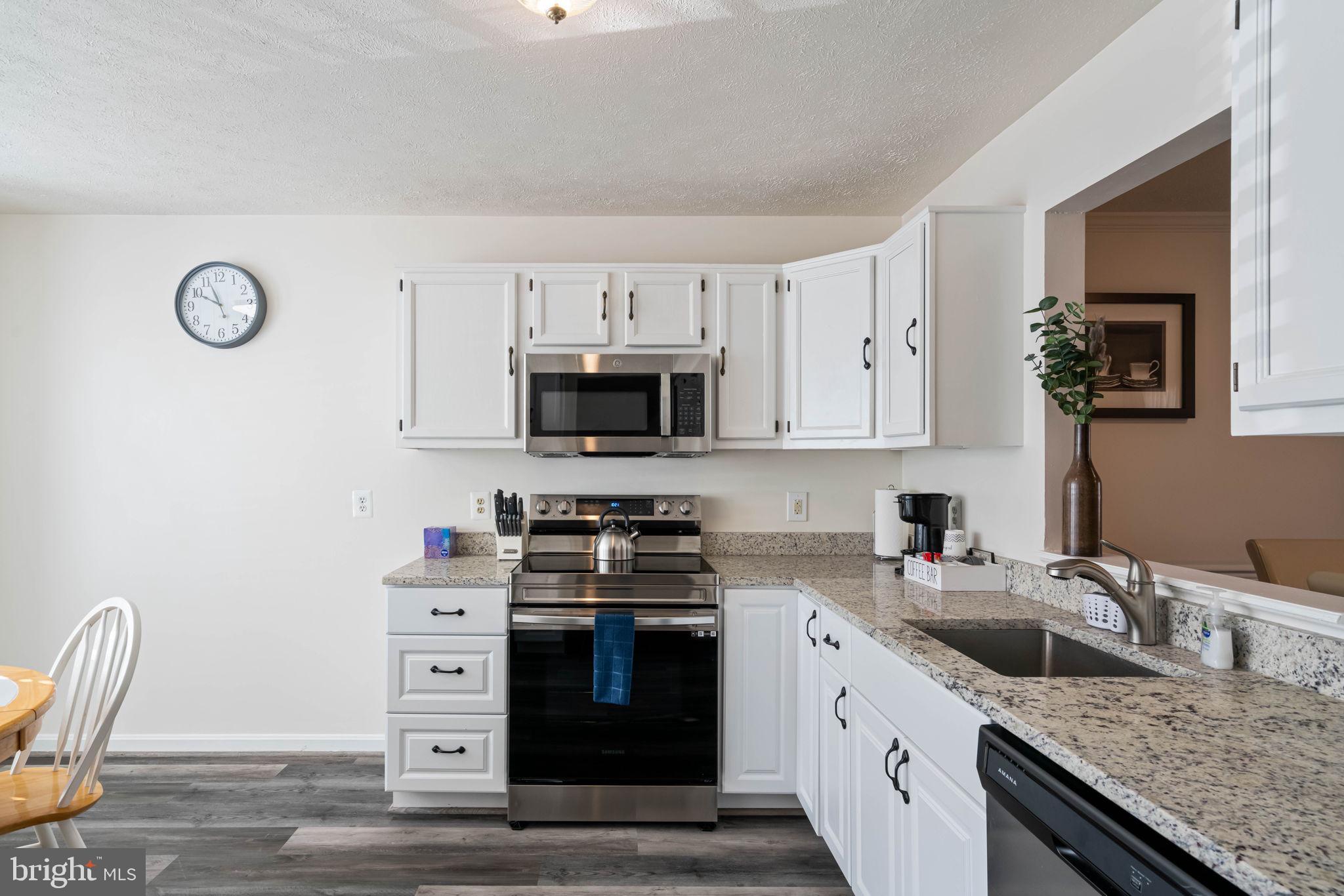 407 Kings Crest Drive Stafford, VA 22554 - Photo 8 of 42 a kitchen with granite countertop a sink a stove and cabinets