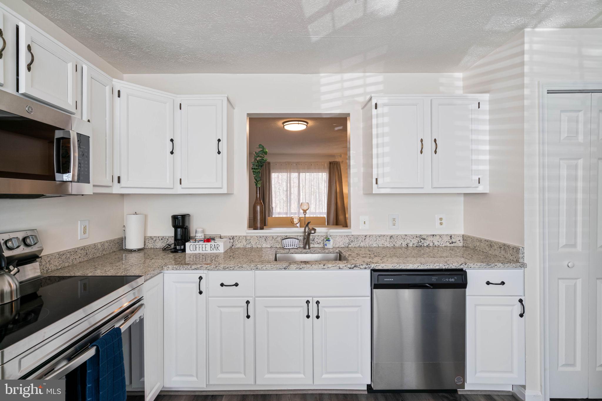 407 Kings Crest Drive Stafford, VA 22554 - Photo 10 of 42 a kitchen with stainless steel appliances granite countertop a sink stove and cabinets