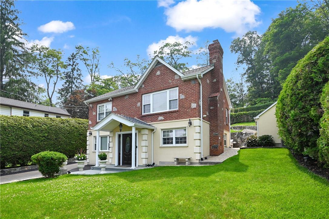 a view of a house with a yard and deck