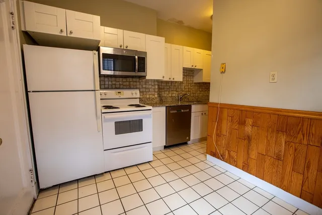 a kitchen with a refrigerator sink and microwave