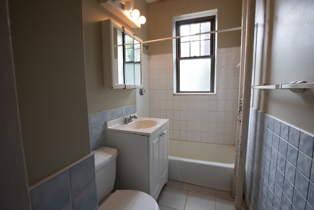 153 Strathmore Road, Unit 4 Boston, MA 02135 - Photo 4 of 9 a bathroom with a sink toilet and shower