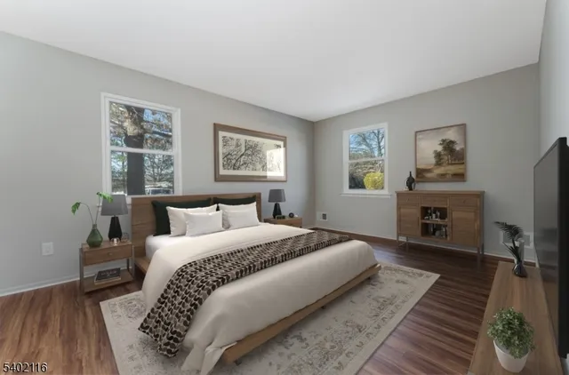 a bedroom with bed and a flat screen tv