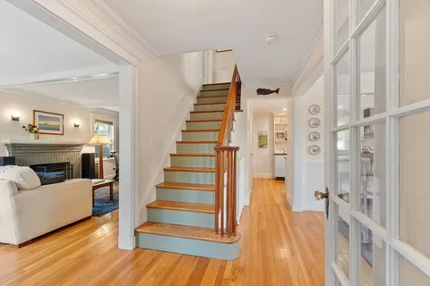 a view of a living room and entryway with wooden floor
