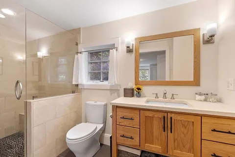 a bathroom with a toilet sink and mirror