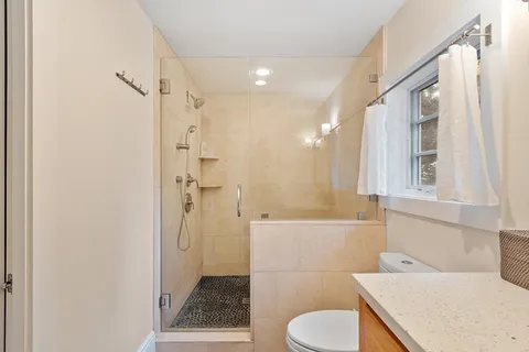 a bathroom with a sink toilet and shower