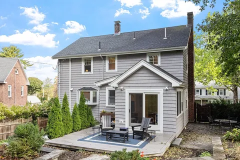 a front view of a house with yard and trees