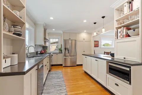 a kitchen with stainless steel appliances granite countertop a sink and cabinets