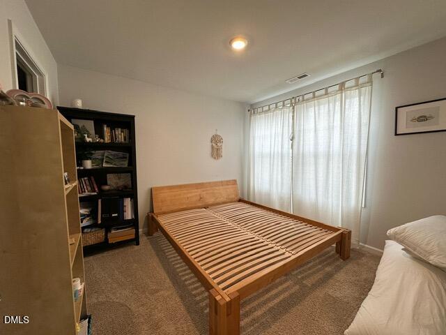 517 Flat Ford Road Hillsborough, NC 27278 - Photo 19 of 27 a bedroom with a bed and a book shelf