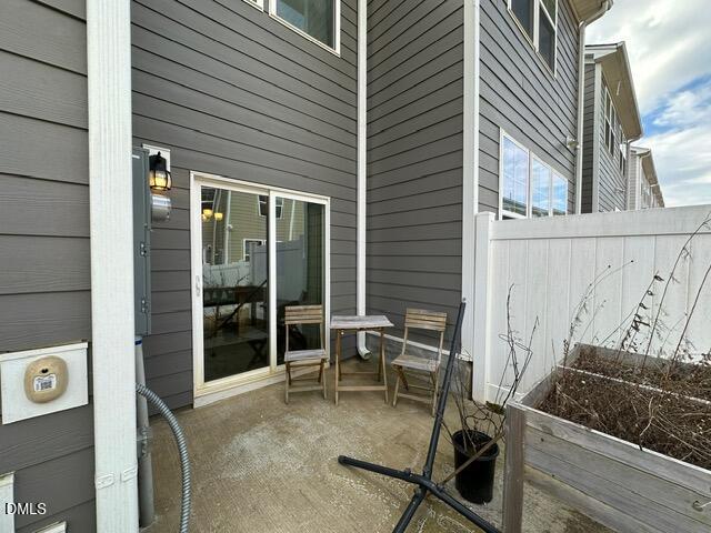 517 Flat Ford Road Hillsborough, NC 27278 - Photo 25 of 27 a view of a patio with table and chairs and wooden fence