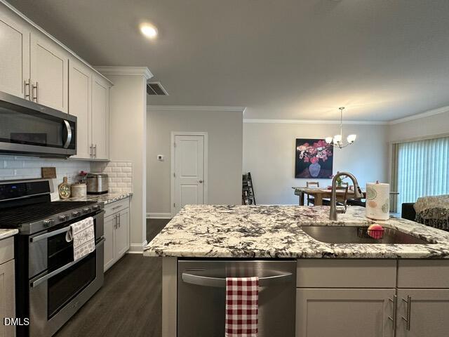 517 Flat Ford Road Hillsborough, NC 27278 - Photo 7 of 27 a kitchen with kitchen island granite countertop a sink cabinets and stainless steel appliances