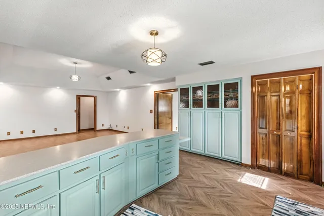 a spacious bathroom with a granite countertop sink and a large mirror