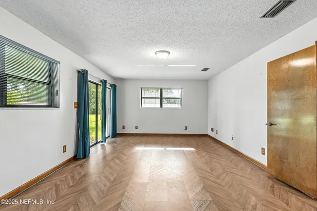 a view of a big room with windows and closet