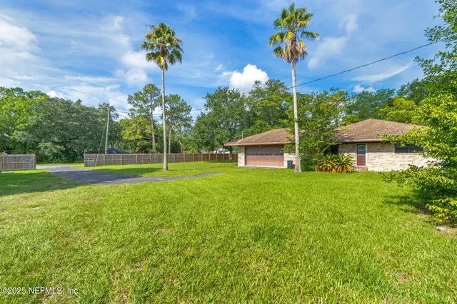 a view of a house with a backyard