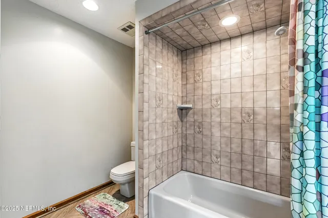 a bathroom with a toilet and shower