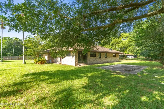 a view of a house with a backyard