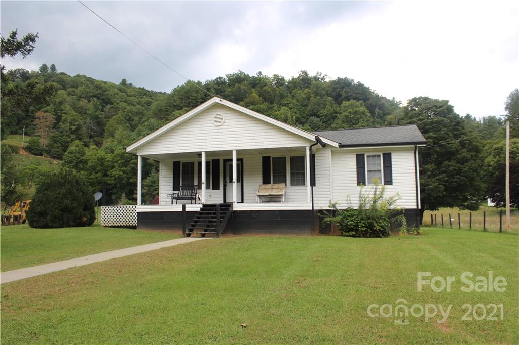 718 Bald Mountain Road Burnsville, NC 28714 - Photo 1 of 20 a front view of a house with garden