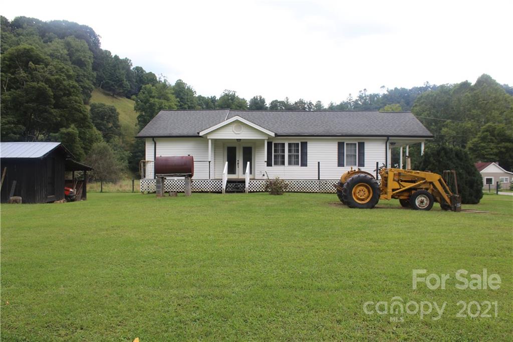 718 Bald Mountain Road Burnsville, NC 28714 - Photo 15 of 20 a front view of a house with garden