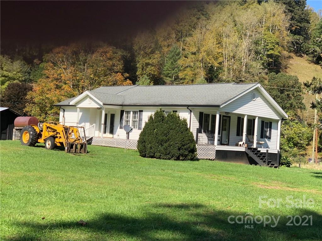 718 Bald Mountain Road Burnsville, NC 28714 - Photo 16 of 20 a front view of a house with a garden and yard