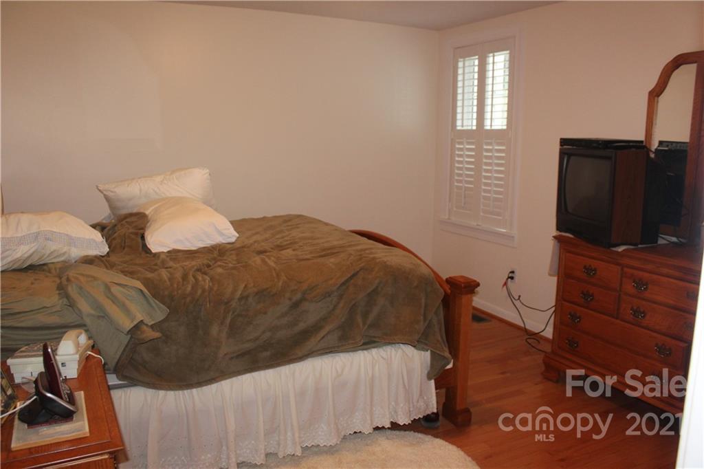 718 Bald Mountain Road Burnsville, NC 28714 - Photo 8 of 20 a bedroom with a bed and flat screen tv