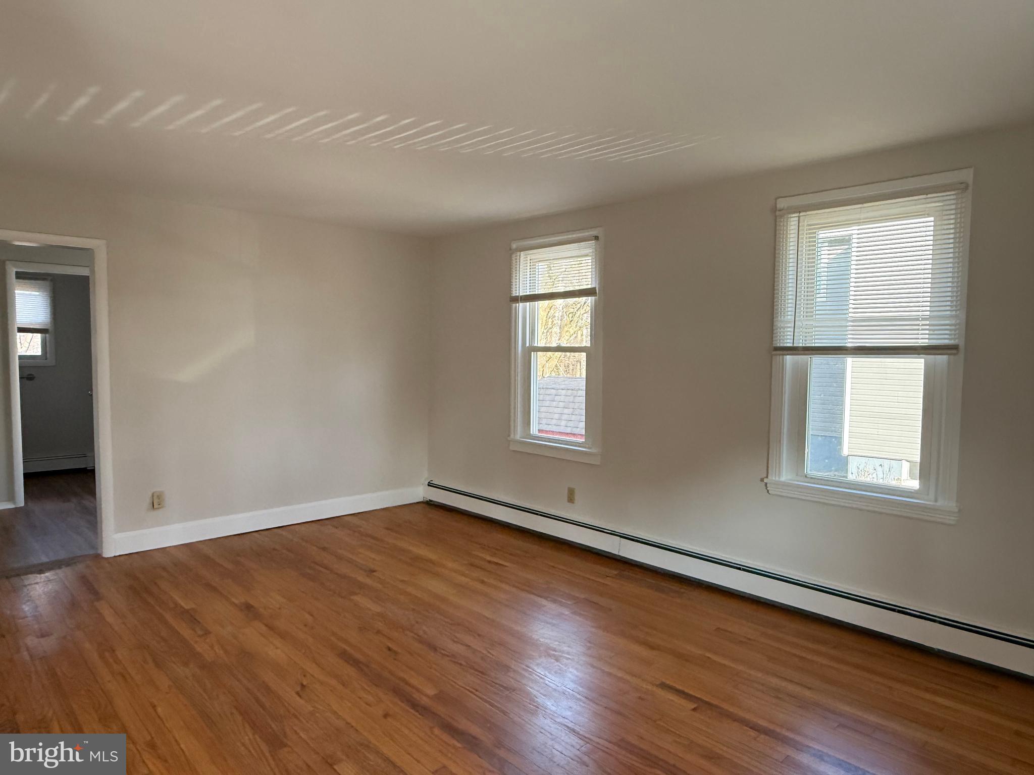 121 East Harmony Road West Grove, PA 19390 - Photo 12 of 50 an empty room with wooden floor and windows